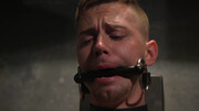Gagged male slave waits for his master to decide on the punishment