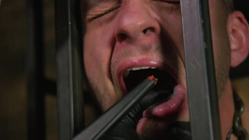 Caged male slave obeys his master's sexual desires